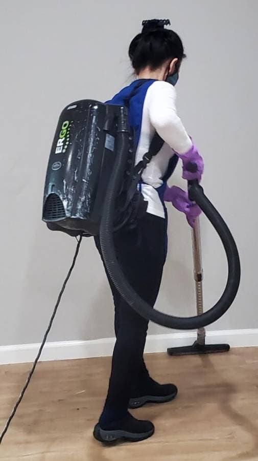 Vacuuming furniture and upholstery during detailed home cleaning